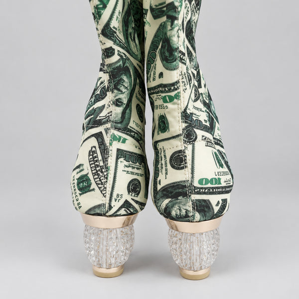 High-heeled shoes with dollar bill design on a white surface